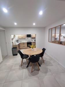 a dining room with a table and chairs and a kitchen at Chez Cricri, modern accommodation in Bizanet +10 photos