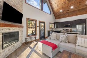 a living room with a couch and a fireplace at Anchor Point- Hot Tub, Firepit, Ping Pong in Rogers