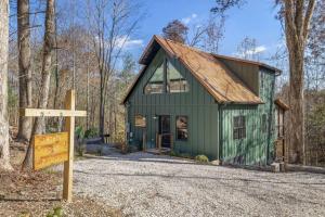 a green barn with a sign in front of it at Anchor Point- Hot Tub, Firepit, Ping Pong in Rogers