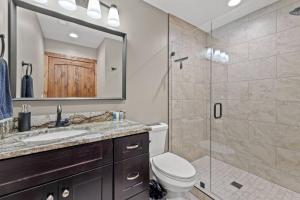 a bathroom with a shower and a toilet and a sink at Anchor Point- Hot Tub, Firepit, Ping Pong in Rogers +21 photos