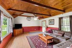 a living room with a couch and a tv at Hidden Treasure- Private Pool, Pond, 1600 Acres in Clay City