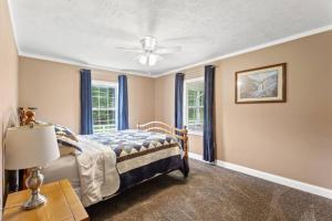 a bedroom with a bed and a ceiling fan at Hidden Treasure- Private Pool, Pond, 1600 Acres in Clay City +31 photos