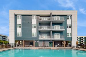 a building with a pool in front of it at 2 Mi to UF Campus! Modern Luxury Apt w/ Pool in West Hills