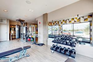 a gym with treadmills and machines in a room at 2 Mi to UF Campus! Modern Luxury Apt w/ Pool in West Hills