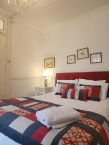 a bedroom with two beds with colorful blankets at Casa Mackenna in Valparaíso