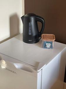 a black tea kettle on top of a white refrigerator at Cà VENDALIS Agriturismo & Cantina in Cinto Euganeo