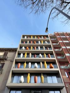 a building with lots of vases on the side of it at Palazzo Le Giare - Luxury Apartments in Bari