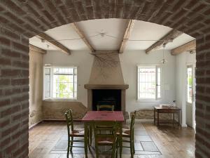 a dining room with a table and a fireplace at Cà VENDALIS Agriturismo & Cantina in Cinto Euganeo