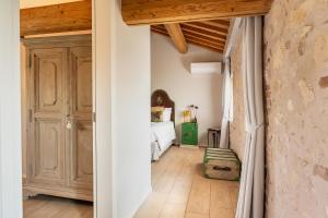 a bedroom with a bed and a wooden ceiling at Magari Estates Boutique Hotel in Colognola ai Colli