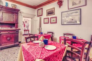 a dining room with tables and chairs with red table cloth at Alloggi B&b Allegri in Venice