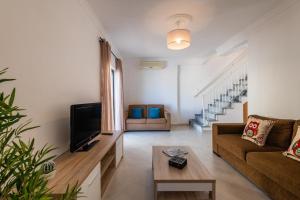 a living room with a couch and a tv at Villa Miramar Gale by Villa Select in Galé