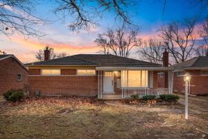 a brick house with a sunset in the background at Furnished Private Room in a Spacious Shared Home#3 in Norton
