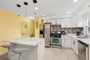 a kitchen with white appliances and yellow walls at Furnished Private Room in a Spacious Shared Home#3 in Norton