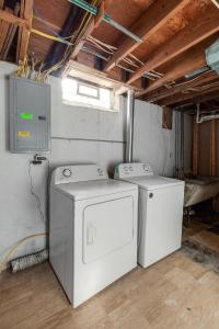two washing machines are sitting in a room at Furnished Private Room in a Spacious Shared Home#3 in Norton +1 photo