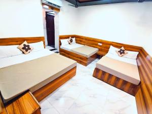 a room with two beds in a room at KHATWADi in Ujjain +12 photos