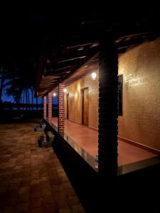 a hallway of a building at night with lights at Suraksha Homestay in Malpe