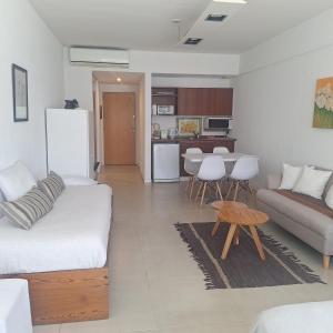 a living room with a couch and a table at Concord Pilar Suite Almendros in Pilar