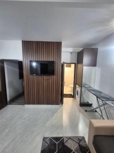 a living room with a television on a wall at Olive Home in Yerevan