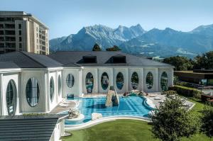a house with a swimming pool with mountains in the background at Casa Casparis in Maienfeld