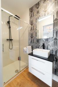 a bathroom with a sink and a shower at Renada Cottage - Dingle Town Centre in Dingle +16 photos