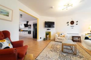 a living room with a couch and a table at Renada Cottage - Dingle Town Centre in Dingle