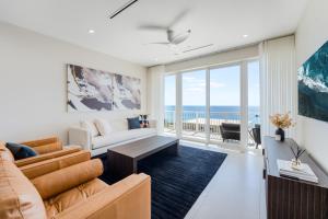 a living room with a couch and a table at Point West Premier Rentals in West Bay