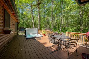 a patio with a table and chairs on a deck at R & R Cabin by Railey Vacations in McHenry