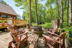 a patio with rocking chairs and a fire pit at R & R Cabin by Railey Vacations in McHenry