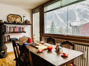 a table in a room with a view of a mountain at GuestHost - Il Dente del Gigante in Courmayeur +27 photos