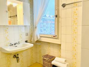 a bathroom with a sink and a window at GuestHost - Il Dente del Gigante in Courmayeur