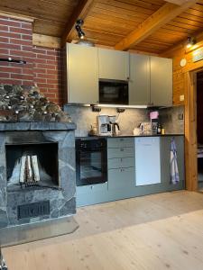 a kitchen with a stone oven and a stove at Ounasloma Holiday Cottages in Enontekiö