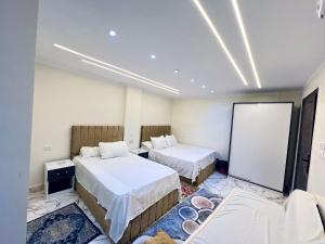 a hotel room with two beds at Star vysta pyramids view inn in Ghaţāţī +7 photos