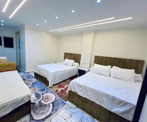 a room with two beds with bowls on the floor at Star vysta pyramids view inn in Ghaţāţī