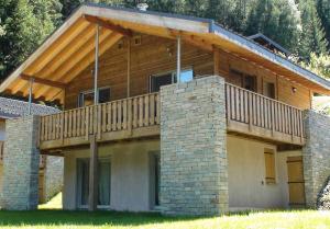 a house with a balcony on top of it at Normalie in Villarodin-Bourget