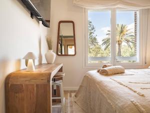 a bedroom with a bed and a desk and a window at Camp Nou Stadium in Barcelona