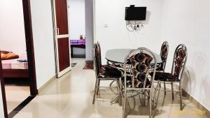 a dining room with a table and four chairs at Angel's Cottage in Munnar