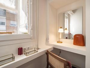 a room with a window and a chair and a mirror at Camp Nou Stadium in Barcelona +36 photos