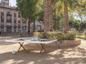 a ping pong table in a park with palm trees at Camp Nou Stadium in Barcelona