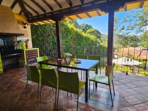 a table and chairs on a patio with a view at La Primavera, casas campestres para familias, paisajes, tranquilidad, cerca al pueblo in Villa de Leyva