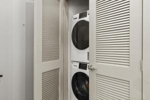 a laundry room with two washer and dryer at Brick & Bed Riverfront Lofts, T 305 in Saint Louis