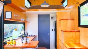 a kitchen in a tiny house with a counter at La Tiny TINY HAUS in Bogotá +25 photos
