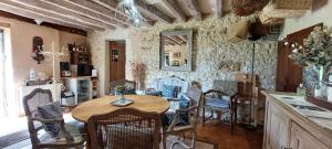 a kitchen and dining room with a table and chairs at Le bourgis in La Chapelle-Montligeon