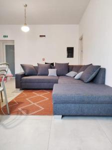 a living room with a blue couch and a table at VAARAK in Bosa