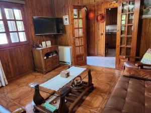 a living room with a couch and a tv at Rincón de Madagascar VV-2192-AS in Arriondas