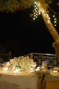 a table with white flowers and lights on it at Dar Arraha Ouirgane in Ouirgane +56 photos