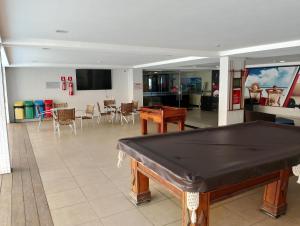 a living room with a ping pong table in it at Praiano Flat Tambaú in João Pessoa