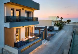 a house with a balcony with a view of the ocean at Diastar Luxury Suites NEW in Heraklio