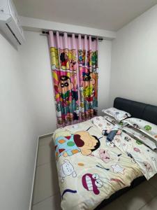 a bedroom with a bed with hello kitty bedding at Shinchan homestay in Skudai