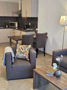 a living room with a couch and a table at Hotel & Mühlenapartments by AVERA Gernsbach GmbH in Gernsbach