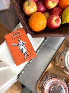 a book sitting on top of a sink with fruit at Pensão Destino in Castelo de Vide